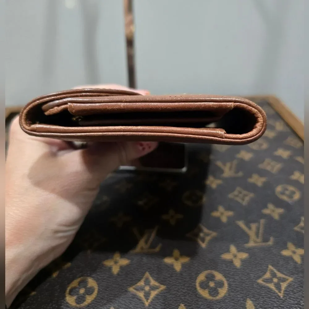 Authentic Louis Vuitton Mahina Amelia Wallet Monogram in brown leather.